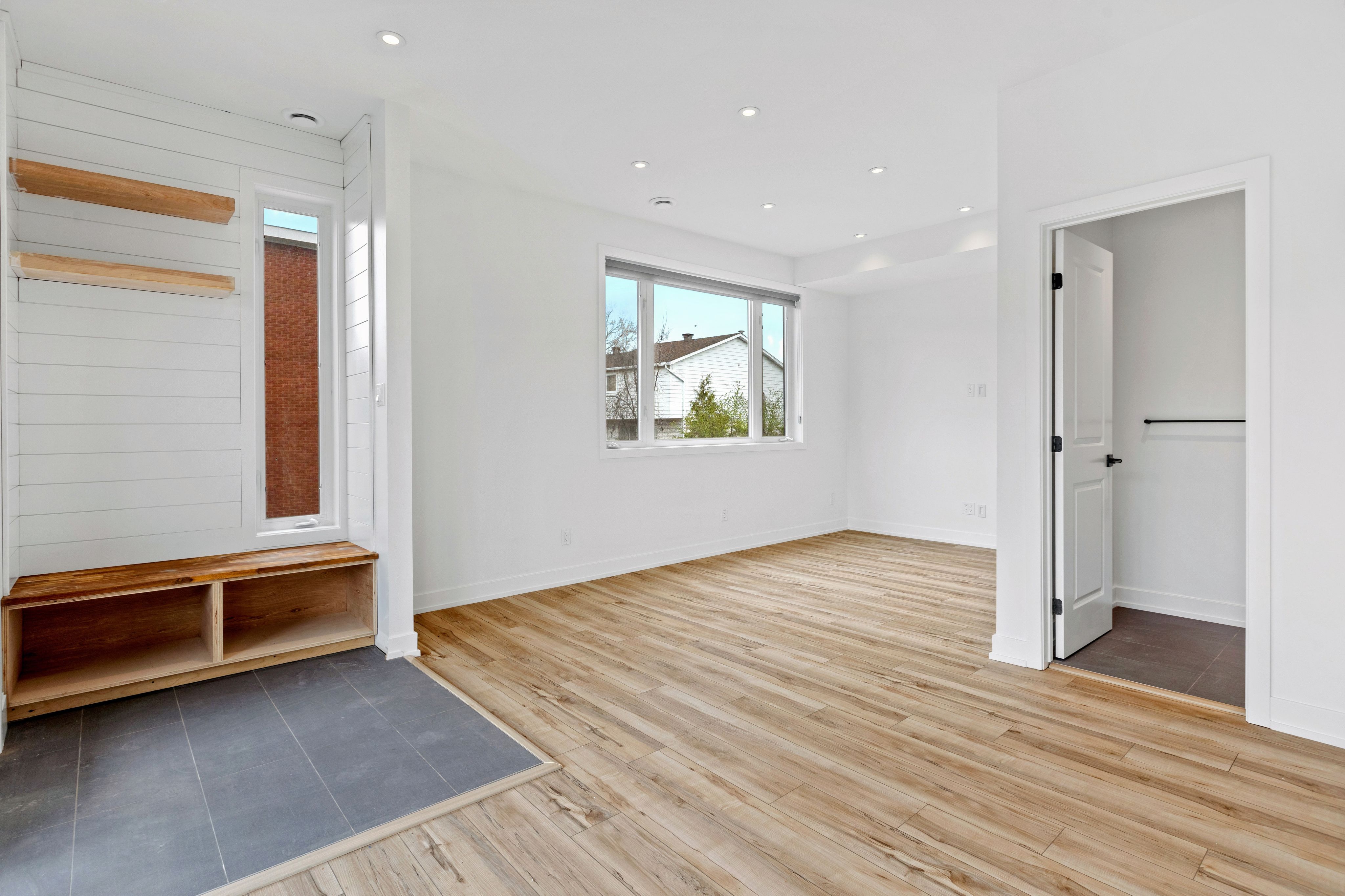 a room with a wood floor and a bench